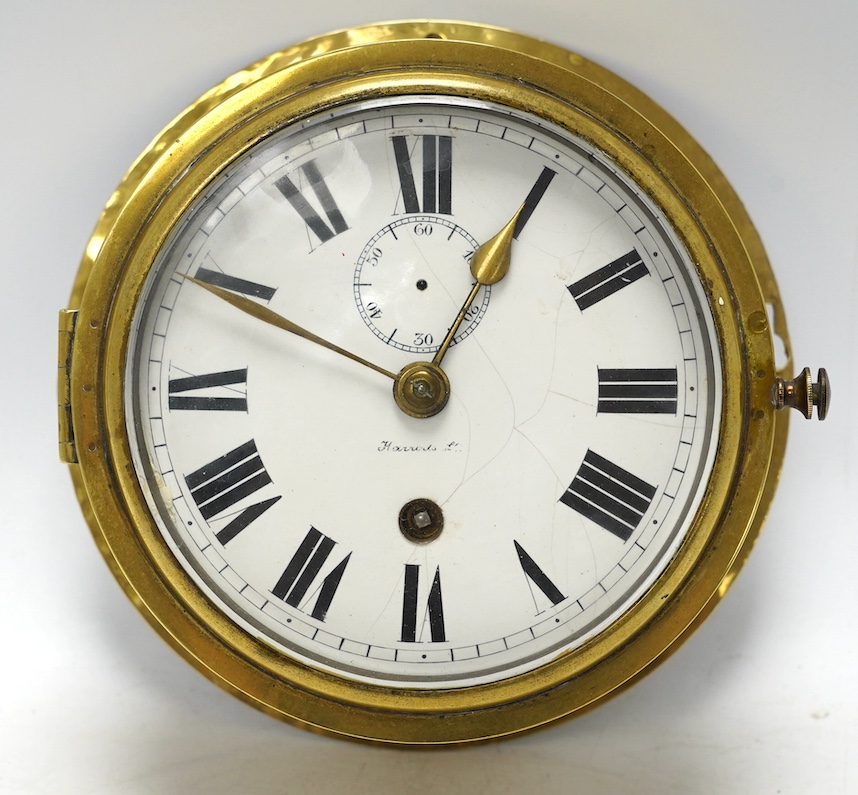 An early 20th century brass bulkhead timepiece retailed by Harrods, dial 13.5cm. Condition - poor to fair, seconds hand missing and some cracks to enamel dial